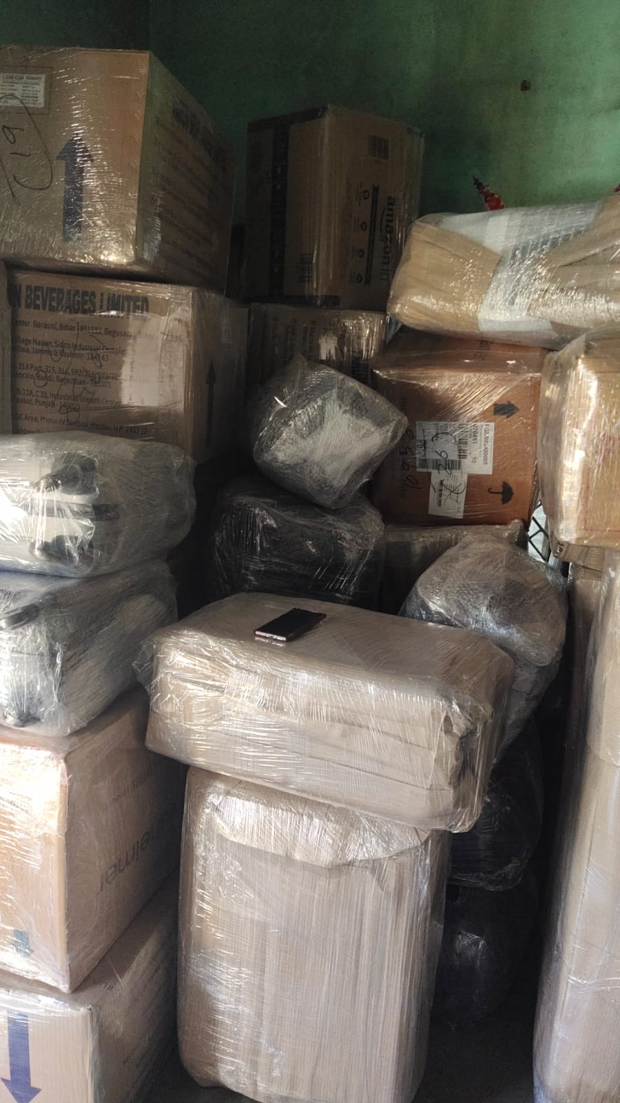 Movers carrying packed boxes out of a home